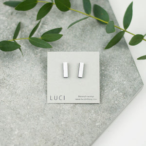 The earrings are handmade from local wood, features sterling silver studs.